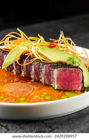 tuna tataki with vegetables and sauce on white plate Royalty-Free Stock Photo #2429298957