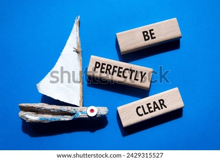 Be perfectly clear symbol. Concept words Be perfectly clear on wooden blocks. Beautiful blue background with boat. Business and Be perfectly clear concept. Copy space Royalty-Free Stock Photo #2429315527