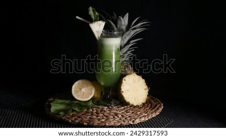 Vegetable juice with pineapple topping black background