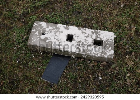 Concrete block dirty with white paint , a theme symbolizing botching the job