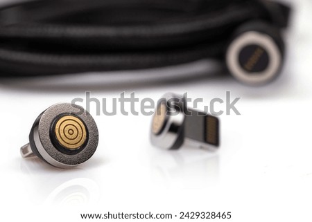 Magnetic charger wire for phone on white background.