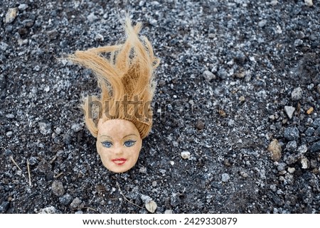 doll head in the mud