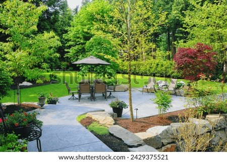 A carefully designed landscaped back yard. Royalty-Free Stock Photo #2429375521