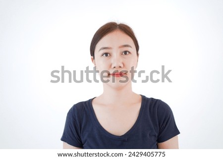 Smart and good looking Asian beautiful young woman in dark blue color t-shirt standing for portrait photography on white background and poses to camera. Asian young woman portrait. Royalty-Free Stock Photo #2429405775