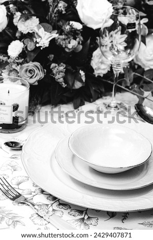 beautiful plate and fresh perfect colorful flowers standing on luxury table