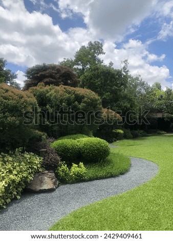 path in the Japanese-style garden and its decorated flowers and green stuff Royalty-Free Stock Photo #2429409461