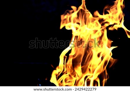 Background of the flame in the oven. Tongues of fire in a brick fireplace. Fire texture.