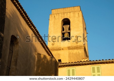 Gassin church bell tower in a warm light sun.  Royalty-Free Stock Photo #2429440807