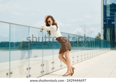 Smiling young woman standing on observation deck