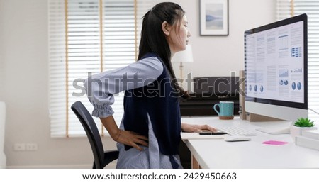 Asia young people cramp low body muscle worry in chronic tough issue, arthritis sciatica spine hip risk. Staff tired weak stress workforce job effect from bad posture sit on chair office syndrome. Royalty-Free Stock Photo #2429450663