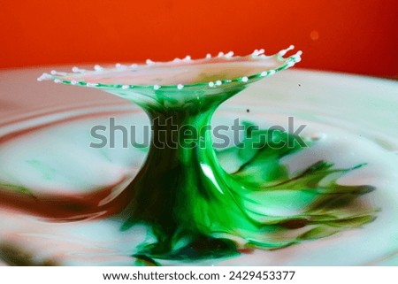 Green Liquid Splash on Red Background, High-Speed Close-Up