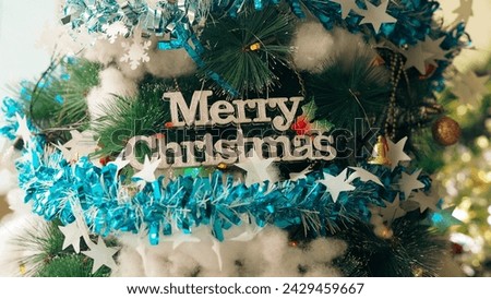 The text "Merry Christmas" hangs on the christmas tree