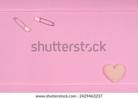 Background material of heart emblem on pink fabric