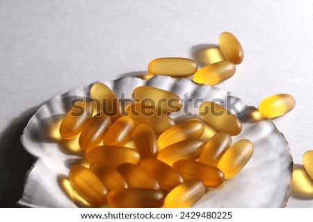everyday supplements, wellness, multivitamin, healthy lifestyle concept. Vitamins Omega 3 on shell on white background. copy space. Royalty-Free Stock Photo #2429480225