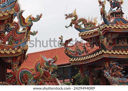 Colorful ancient dragon head statue, typical asian fantasy style, with religious oriental ornaments in spiritual traditional taiwanese Mazu Hotsu Longfong Temple in Miaoli City, Zhunan, Taiwan, Asia. Royalty-Free Stock Photo #2429494089