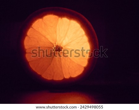Orange fruit against a black background Royalty-Free Stock Photo #2429498055