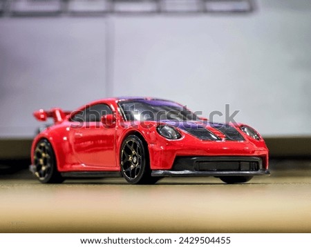 sports red toy car portrait photo with beautiful blurred isolated background high resolution photo countryside of India 