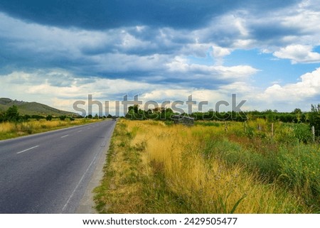 Dramatic  summer sky over empty country road in the foot of Rhodopes mountain .Picture taken on July 11,2014,Plovdiv district,Bulgaria