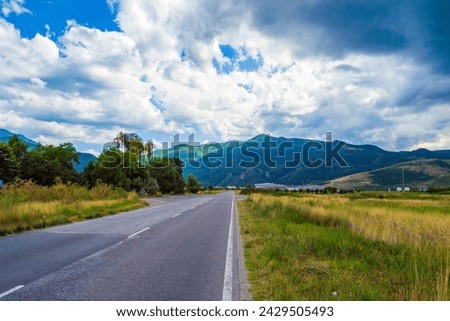Dramatic  summer sky over empty country road in the foot of Rhodopes mountain .Picture taken on July 11,2014,Plovdiv district,Bulgaria