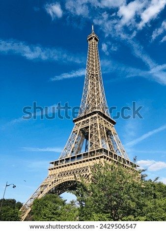 Eiffel Tower with blue sky background and trees
