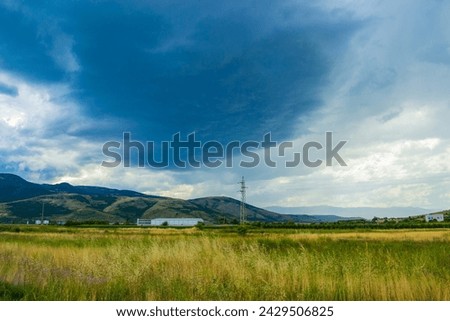 Dramatic rainy clouds in the sky and the approaching rain over summer pastoral landscape .Picture taken on July 11 2014,Krichim town,Plovdiv district Bulgaria
