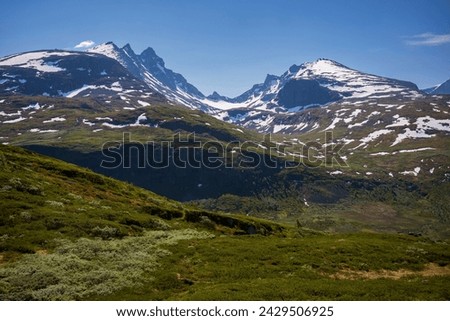 The famous National Tourist Route "Sognefjellsvegen" is where tourists can visit Norway's highest and impost impressive mountain pass in Northern Europe.  Royalty-Free Stock Photo #2429506925
