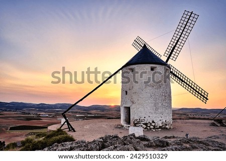 Beautiful sunset in Consuegra, Toledo, Spain. With the windmills that inspired Cervantes for his Don Quixote.