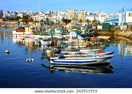 Moored fishing  boats in the Harbor, Lagos, The Algarve, Portugal Royalty-Free Stock Photo #242951959