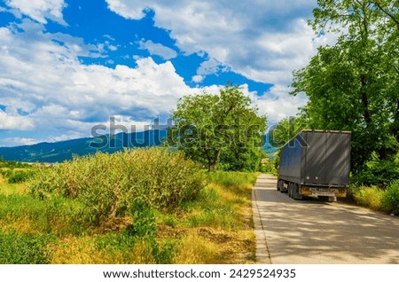 View of winding country road against beautiful blue sky with white fluffy clouds.Picture taken on July 11,2014 in the vicinity of Krichim town in the foot of Rhodope mountain,Bulgaria