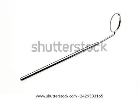 Dental mirror placed on a white background