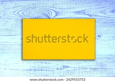 golden blank business card on blue wooden background