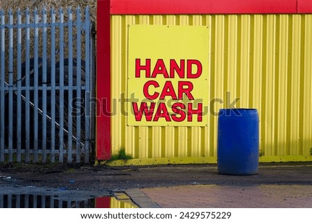Hand car wash sign and water bucket ready for washing