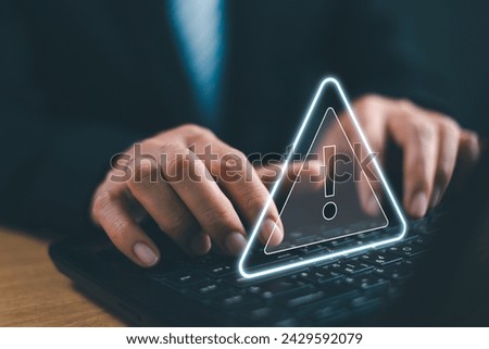 Caution failure system hacked warn alert on notebook. Businessman use computer laptop, triangle caution warning sign for notification error, trouble maintenance. Available internet cybersecurity 