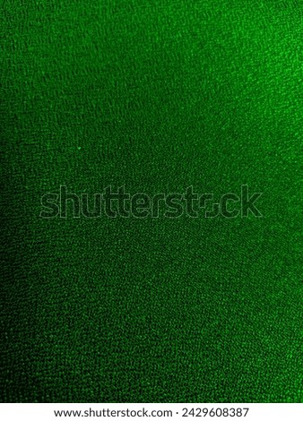 Close-up of a soft, green fabric texture. This high-resolution image is perfect for a variety of uses, including backgrounds, textures, and overlays.