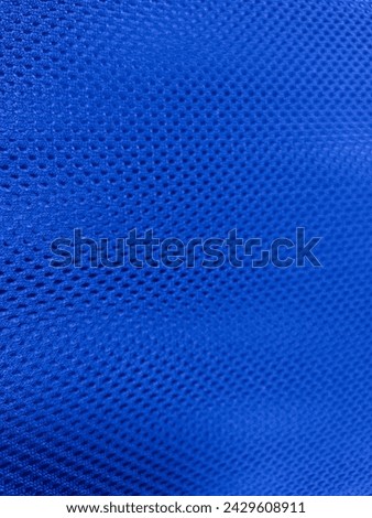 Close-up of a soft, blue fabric texture. This high-resolution image is perfect for a variety of uses, including backgrounds, textures, and overlays.