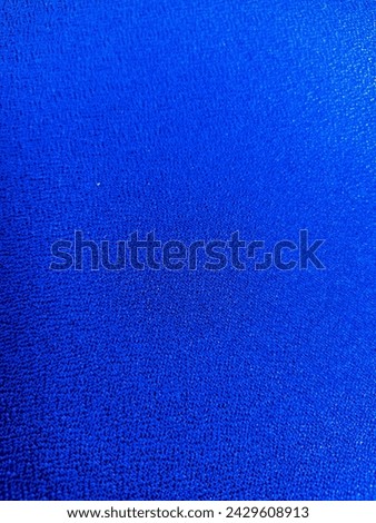 Close-up of a soft, blue fabric texture. This high-resolution image is perfect for a variety of uses, including backgrounds, textures, and overlays.