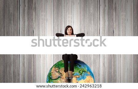 Young woman with blank banner sitting on Earth planet. Elements of this image are furnished by NASA
