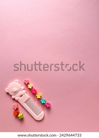 A set of accessories for a little girl on a pink background. Hairpins, combs, hair bands. Fashionable hair accessories for little girls. Flat styling. Top view