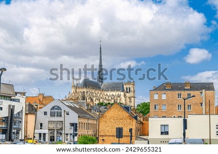 Amiens cityscape with row of buildings and Cathedral Basilica of Our Lady of Amiens Roman Catholic church background in historical city centre, Somme department, Hauts-de-France Region, France