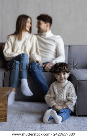 Head shot portrait happy hispanic couple and preschool son sit on sofa at home smiling looking at camera. Bank loan, medical insurance cover for young family, dental services satisfied clients concept