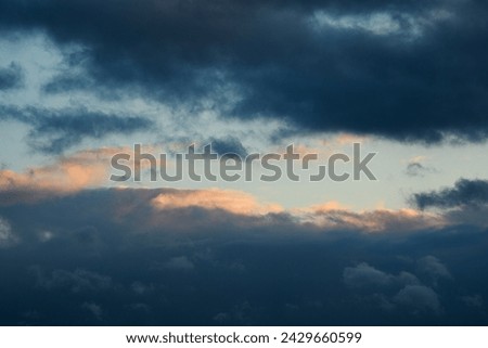 Blue sky during the day. The weather is bad. Fluffy clouds. Light breaks through the clouds. Universal horizontal photo. The background picture. 
