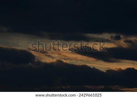 Black sky. Bad weather. Fluffy clouds. Light breaks through the clouds. Universal horizontal photo. The background picture. 
