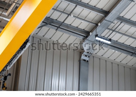 LED lighting motion sensor in an industrial hall Royalty-Free Stock Photo #2429665351