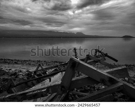 Dramatic black and white background of a sunken boat by the shore Royalty-Free Stock Photo #2429665457