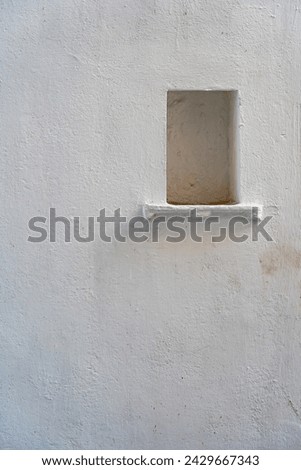 White wall background with a niche in city Udaipur, Rajasthan, India. Close up, copy space
