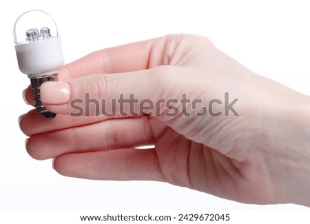 lamp E14 energy-saving compact fluorescent in hand on white background isolation Royalty-Free Stock Photo #2429672045