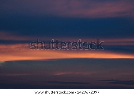 Bright blue clouds at sunset. Yellow lines, romantic sky. Light breaks through the clouds. Universal photos. The background picture. 