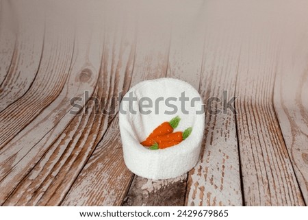 the chair is decorated with carrots. basket for a newborn photo shoot. background for a photo shoot	 Royalty-Free Stock Photo #2429679865