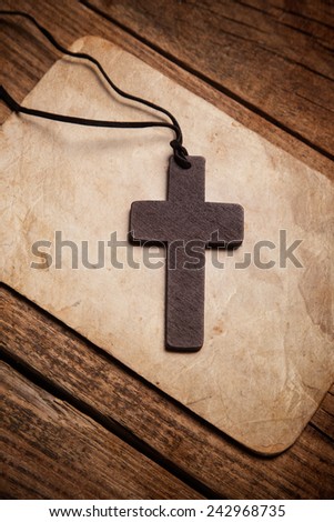 wooden cross on paper background 