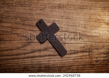 wooden cross on wood background 